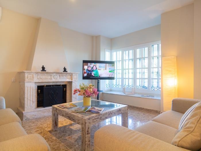 Sitting area is furnished with two comfortable sofas, flat screen TV