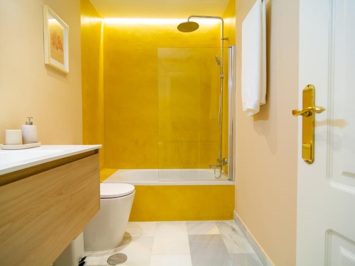 Bathroom with bathtub, rain-head shower, sink, toilet