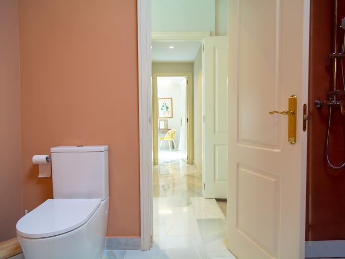 Family bathroom with double sink, two round mirrors, walk-in shower, rain-head shower