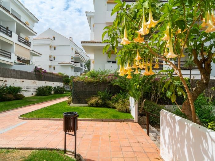 Beautiful beachside urbanization with manicured garden, communal pool and children's pool