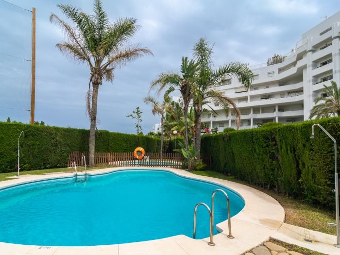 Mediterranean vegetation that surrounds the shared pool and children's pool with outdoor showers